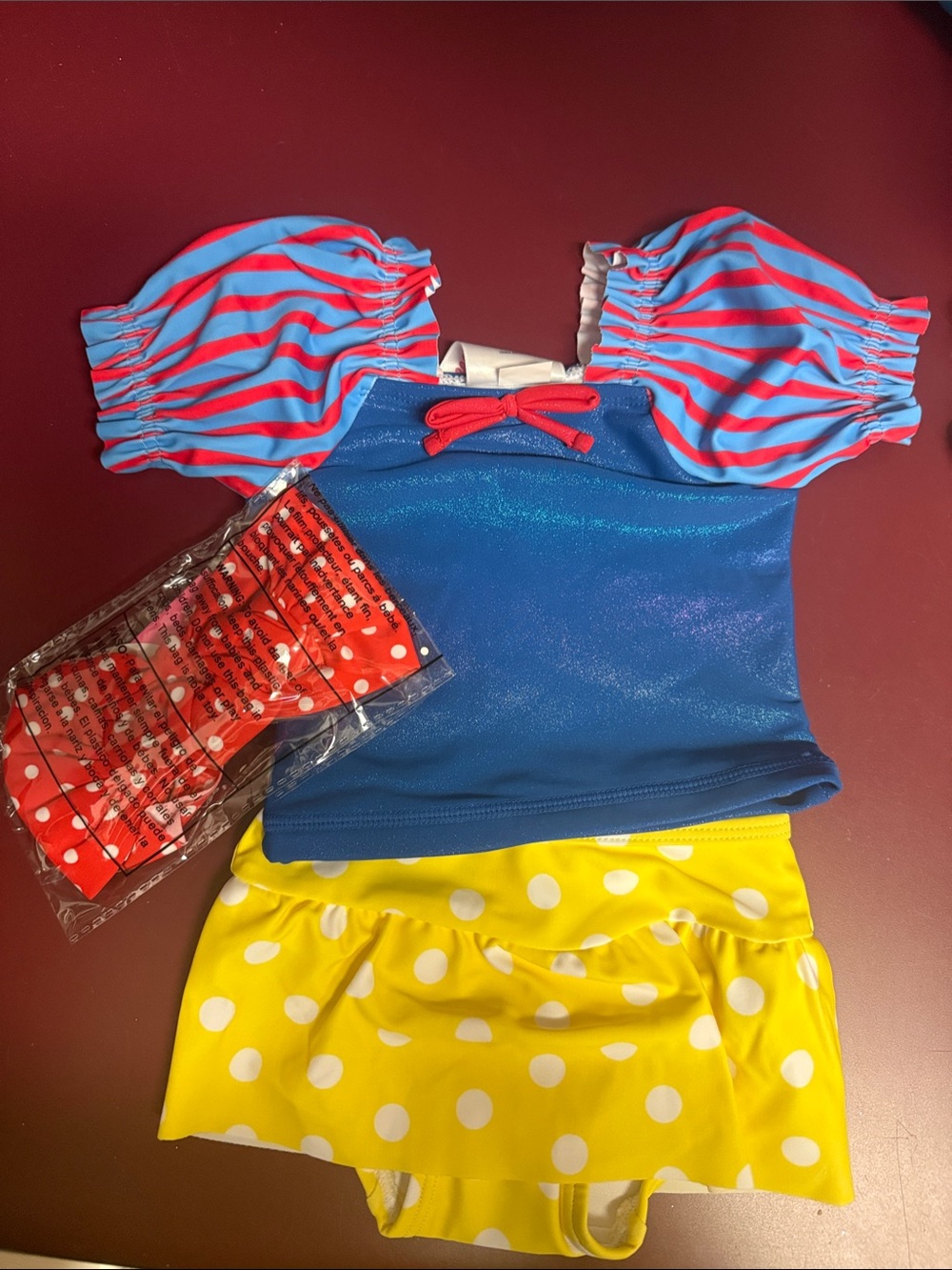 Ruffle Butts Snow White SPF 50 swimsuit.